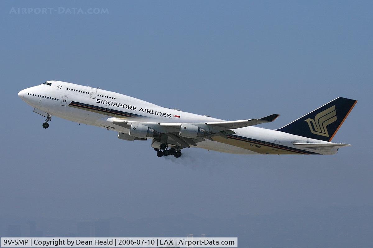 9V-SMP, 2002 Boeing 747-412/BCF C/N 27067, Singapore Airlines 9V-SMP (FLT SIA11) climbing out from RWY 25R enroute to Narita Int'l (RJAA), Japan. Note the condensation over the wings and the brake dust from the main landing gear.