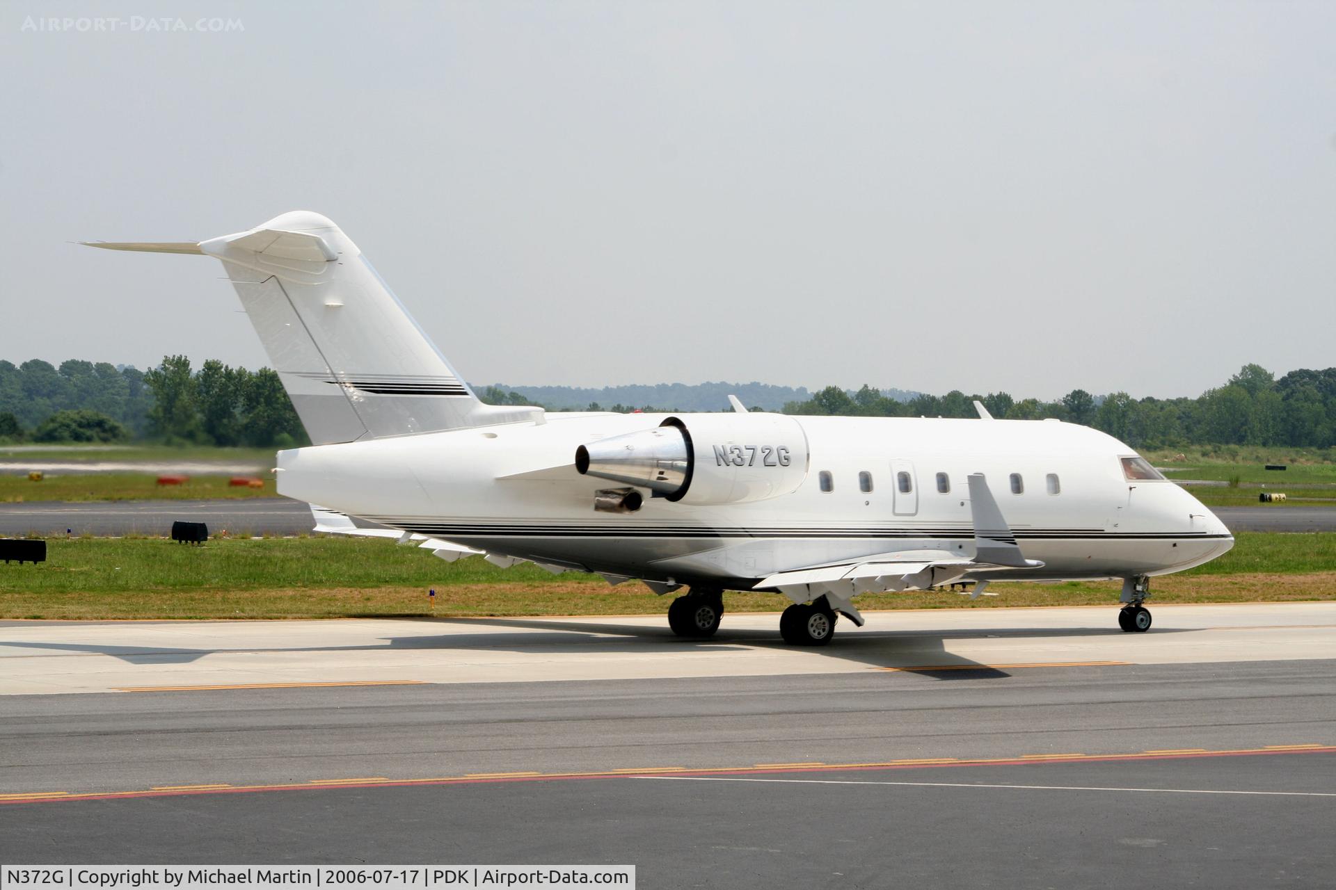 N372G, 1997 Canadair Challenger 604 (CL-600-2B16) C/N 5351, Taxing past Mercury Air Service