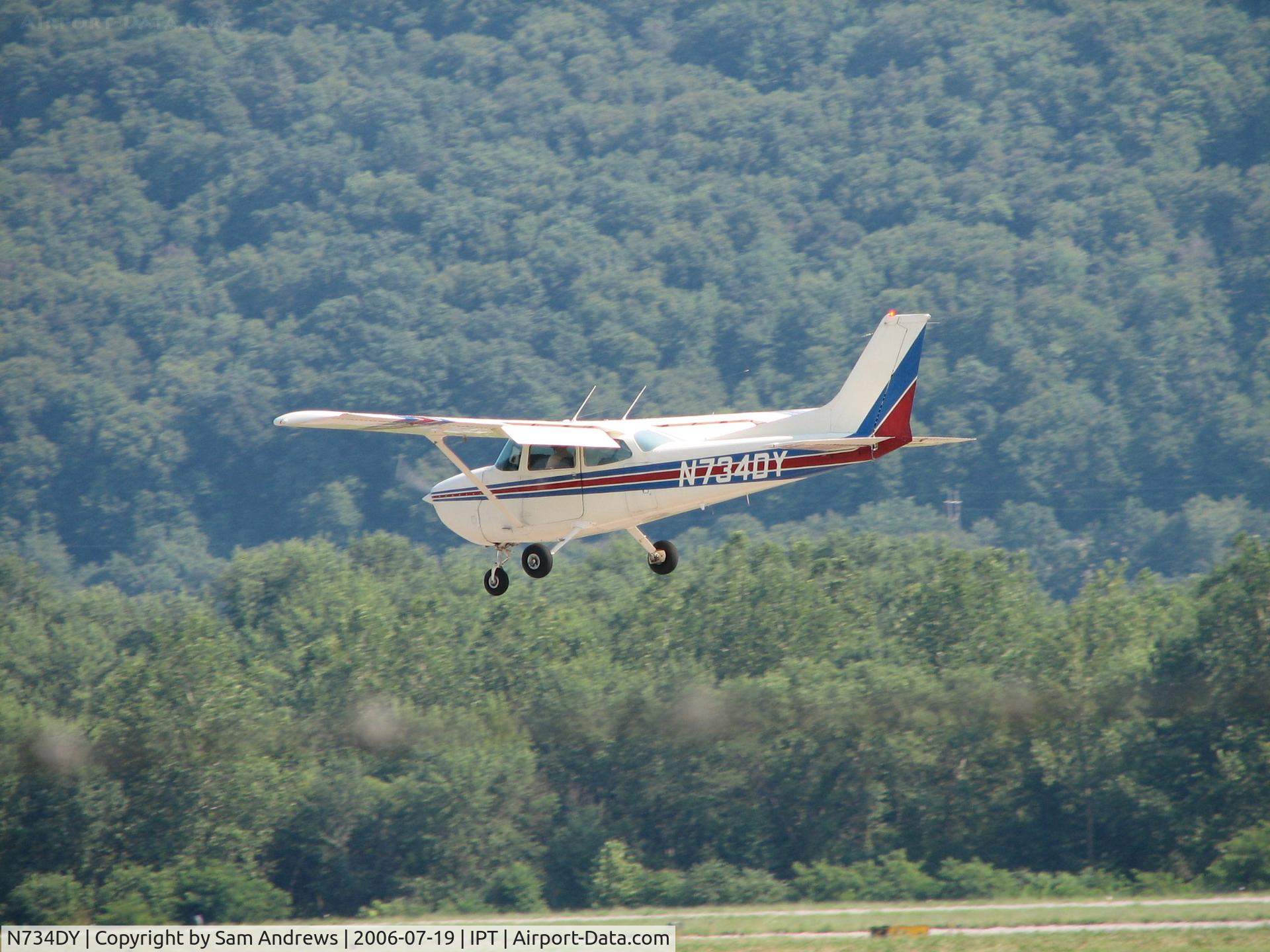 N734DY, 1977 Cessna 172N C/N 17268785, Just about to touch down.  I didn't get the landing because he went behind a building.