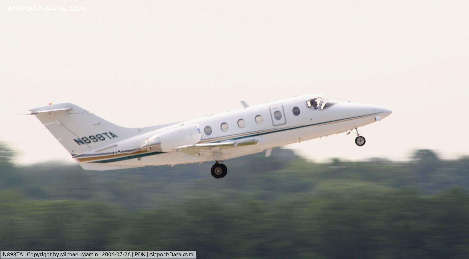 N898TA, 2000 Raytheon Beechjet 400A C/N RK-295, Option 898 departing 20L enroute to JAX