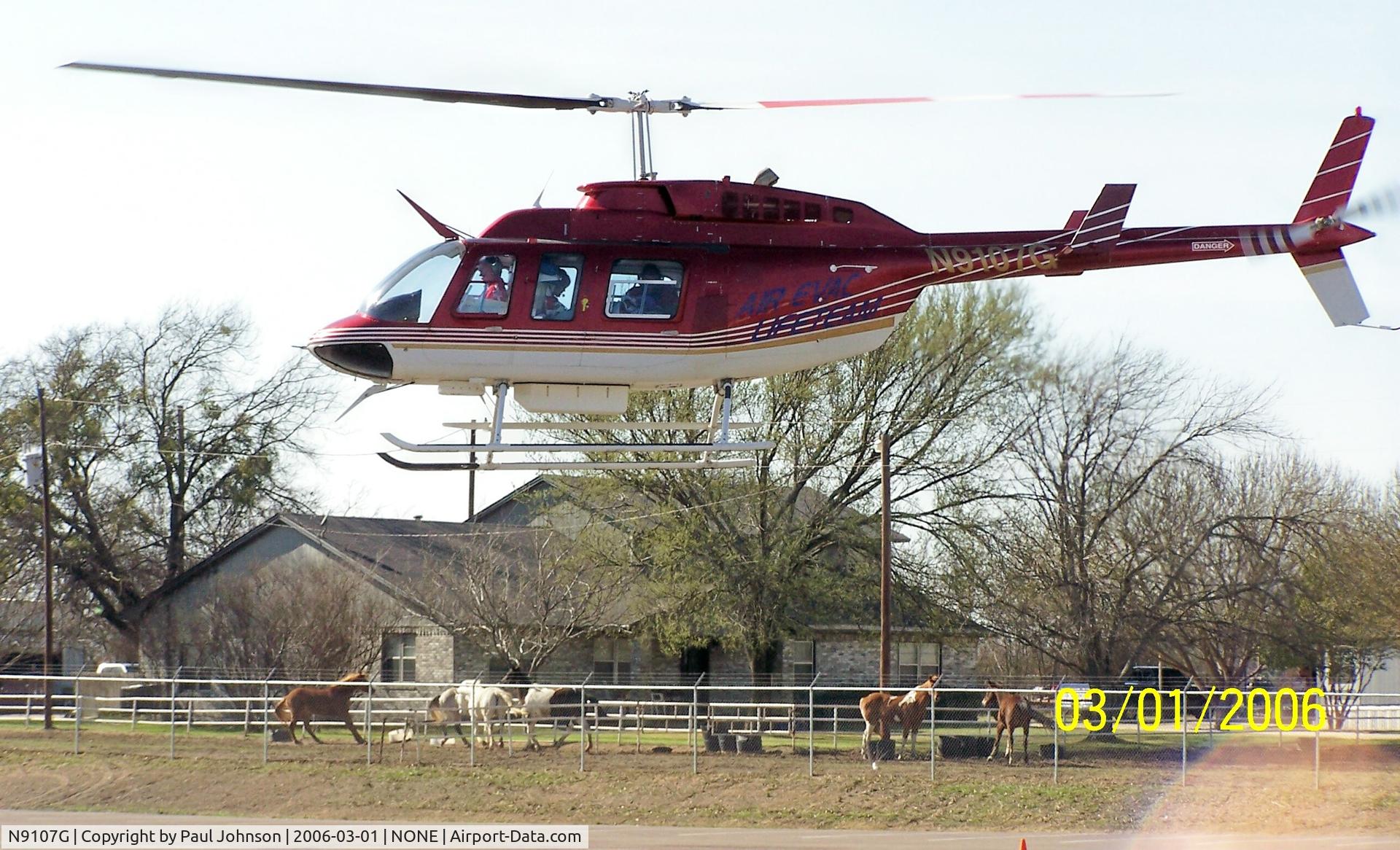 N9107G, 1990 Bell 206L-3 LongRanger III C/N 51421, N9107G Taking off from parking lot transporting accident victim to a local hospital