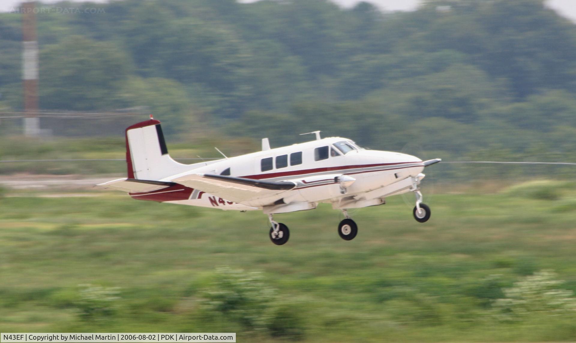 N43EF, Beech 65 (LF-23F) C/N LF-48, Starting to tuck in gear after departure