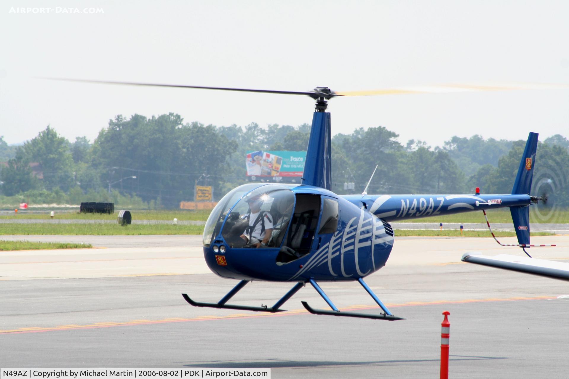 N49AZ, Robinson R44 II C/N 10924, Departing Mercury Air Center after dropping off passenger.