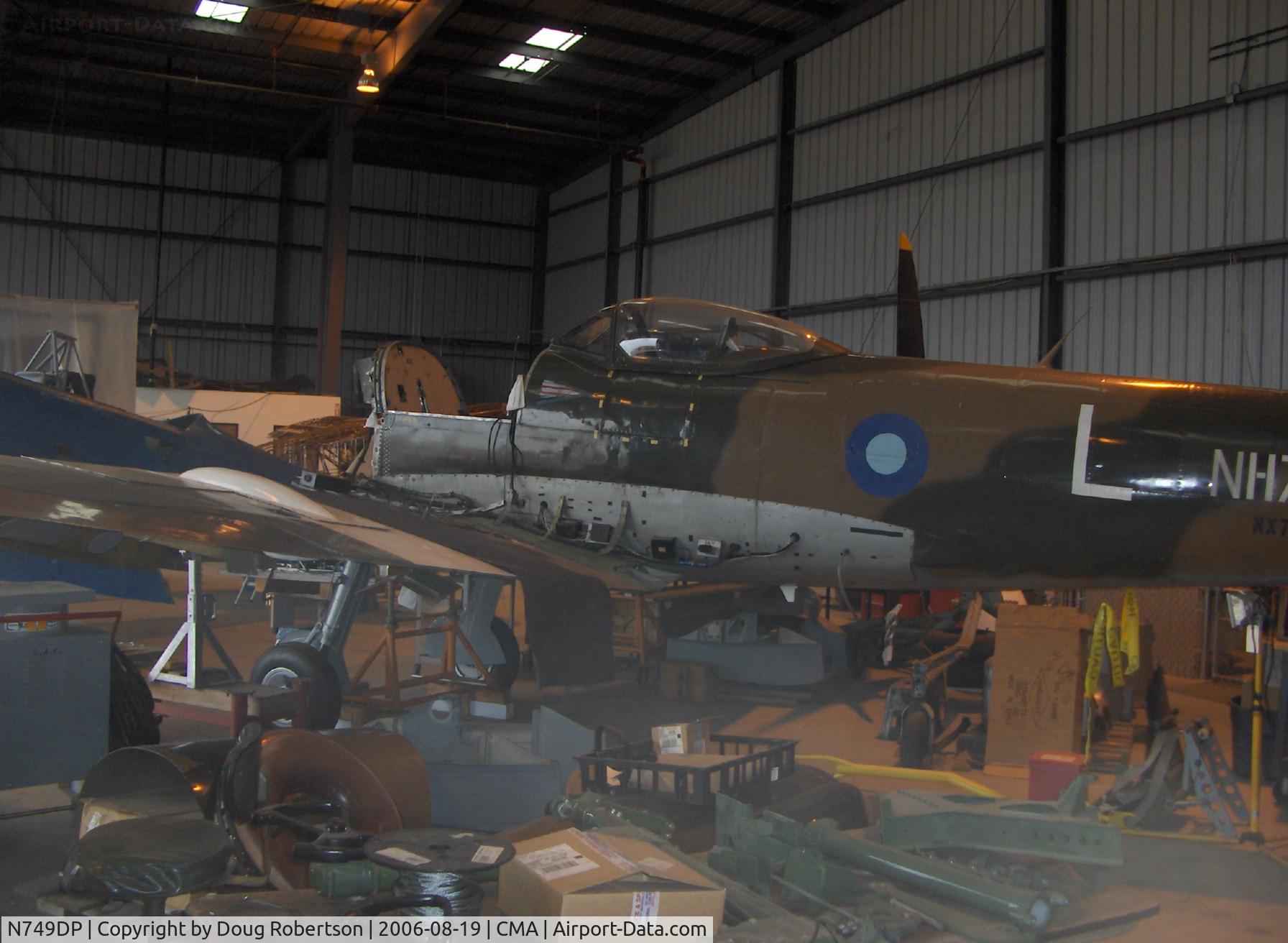 N749DP, 1945 Supermarine Spitfire XIV C/N 6S/583887, In restoration as NX749DP-1945 Vickers/Supermarine SPITFIRE MK XIVe, Rolls Royce Griffon 65 2,050 Hp V-12, the high altitude design MK XIVe has more power, a cut down dorsal fuselage and larger fin and rudder, engine out, crowded access prevents full view