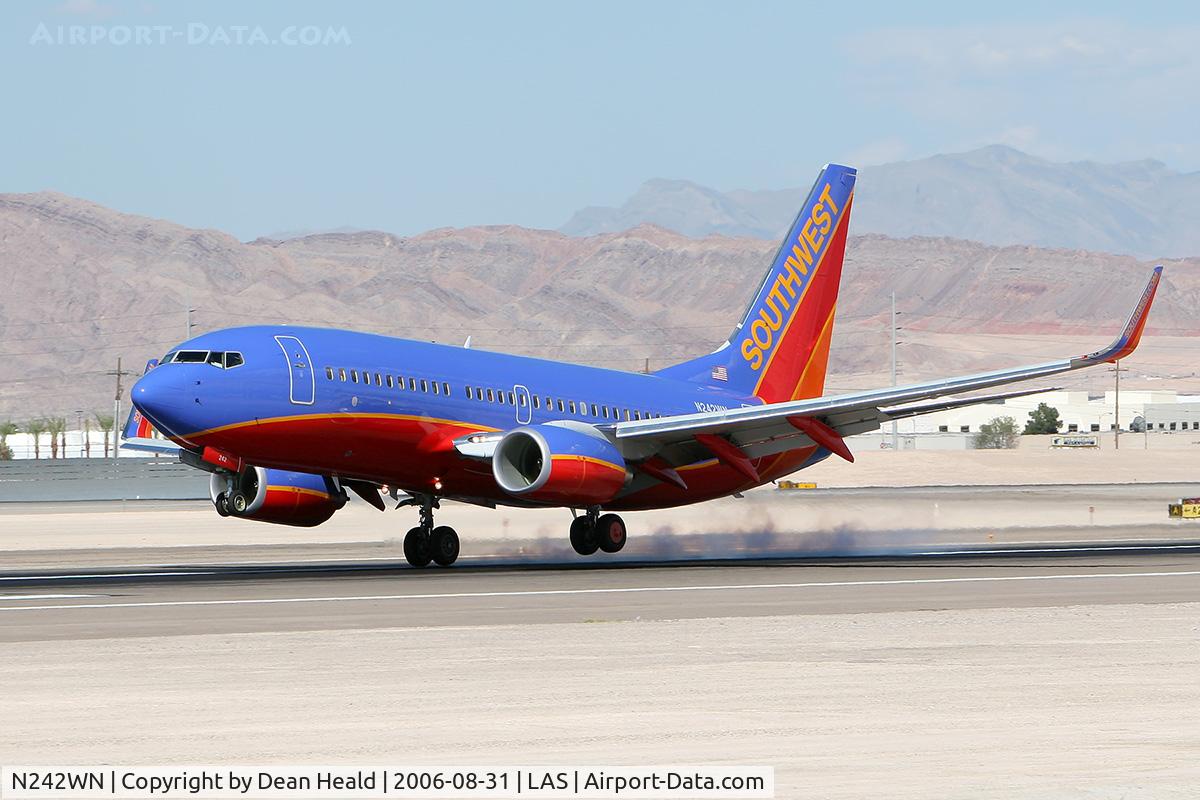 N242WN, 2006 Boeing 737-7H4 C/N 32505, Southwest Airlines N242WN touching down on the right main gear first on RWY 25L.