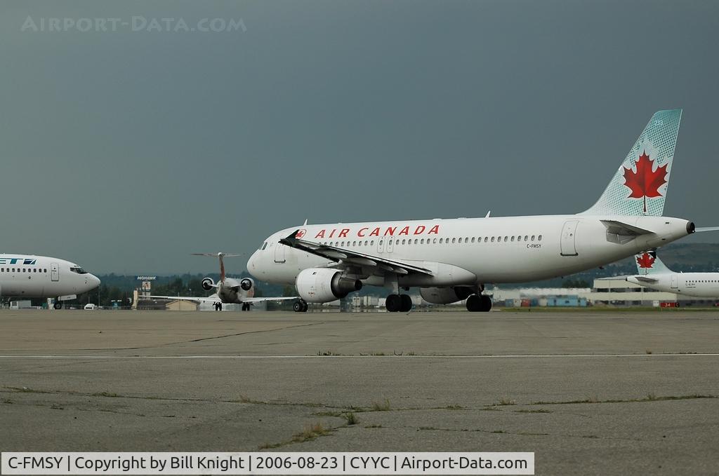 C-FMSY, 1992 Airbus A320-211 C/N 384, #4 in line.  Big storm coming in, down to one runway.