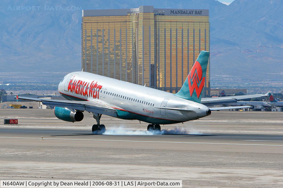 N640AW, 1994 Airbus A320-232 C/N 448, America West N640AW touching down on RWY 25L with the Mandalay Bay Hotel & Resort in the background.