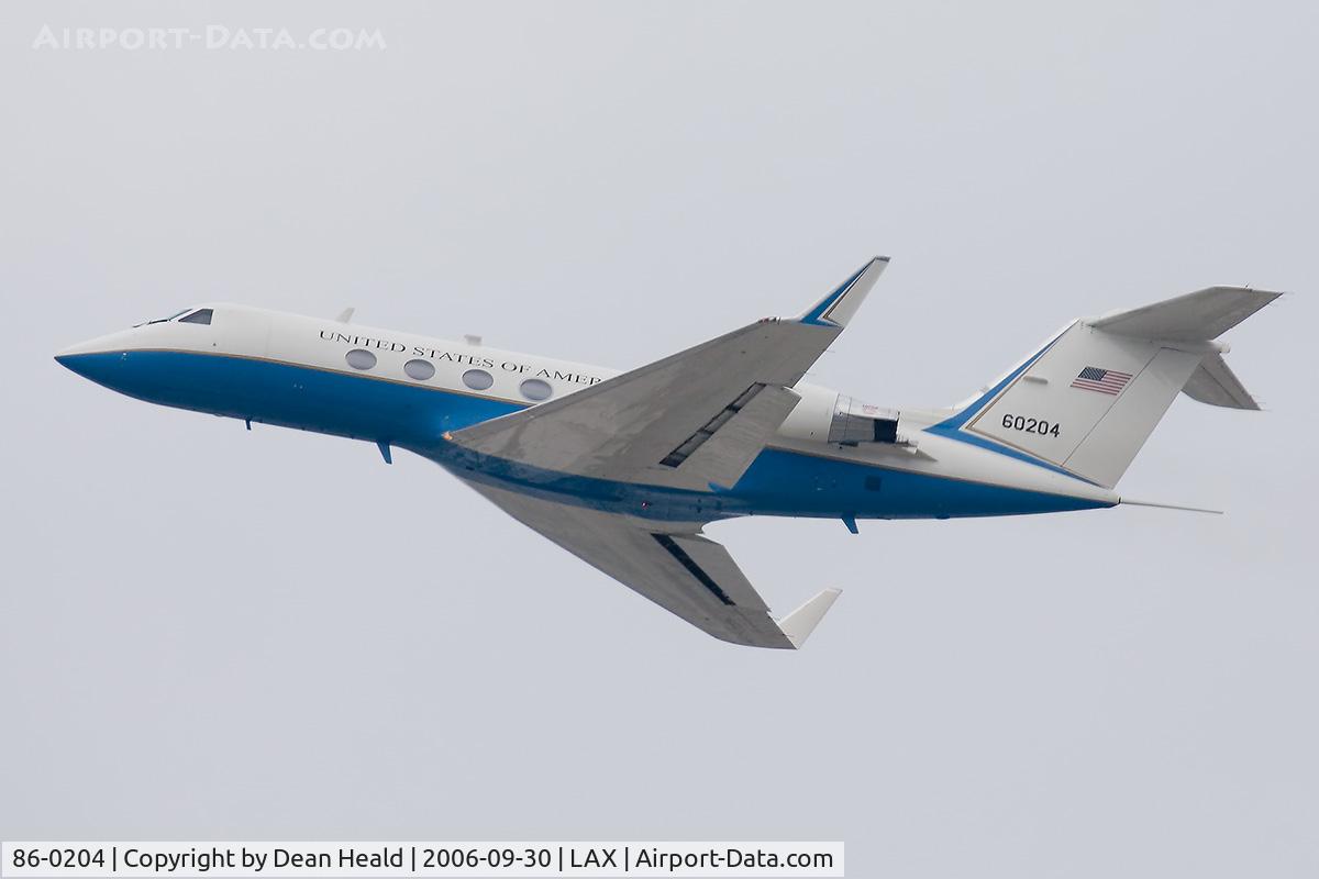 86-0204, Grumman C-20B Gulfstream III C/N 476, United States Air Force C-20B 86-0204 climbing out from RWY 25R on a cloudy & hazy day.