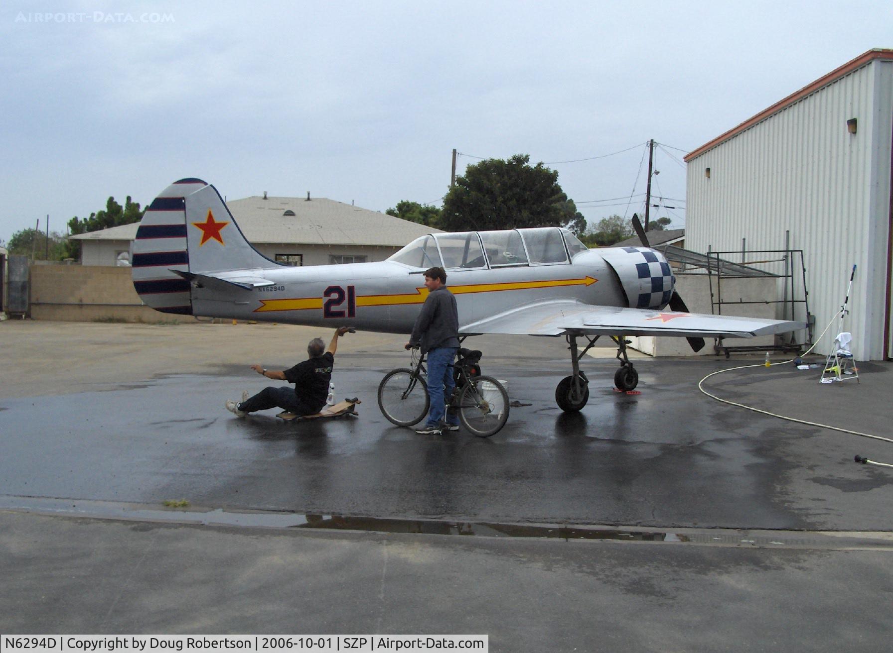 N6294D, 1983 Yakovlev Yak-52 C/N 833611, 1983 Yakovlev YAK 52, bath time, owner pilot under aircraft