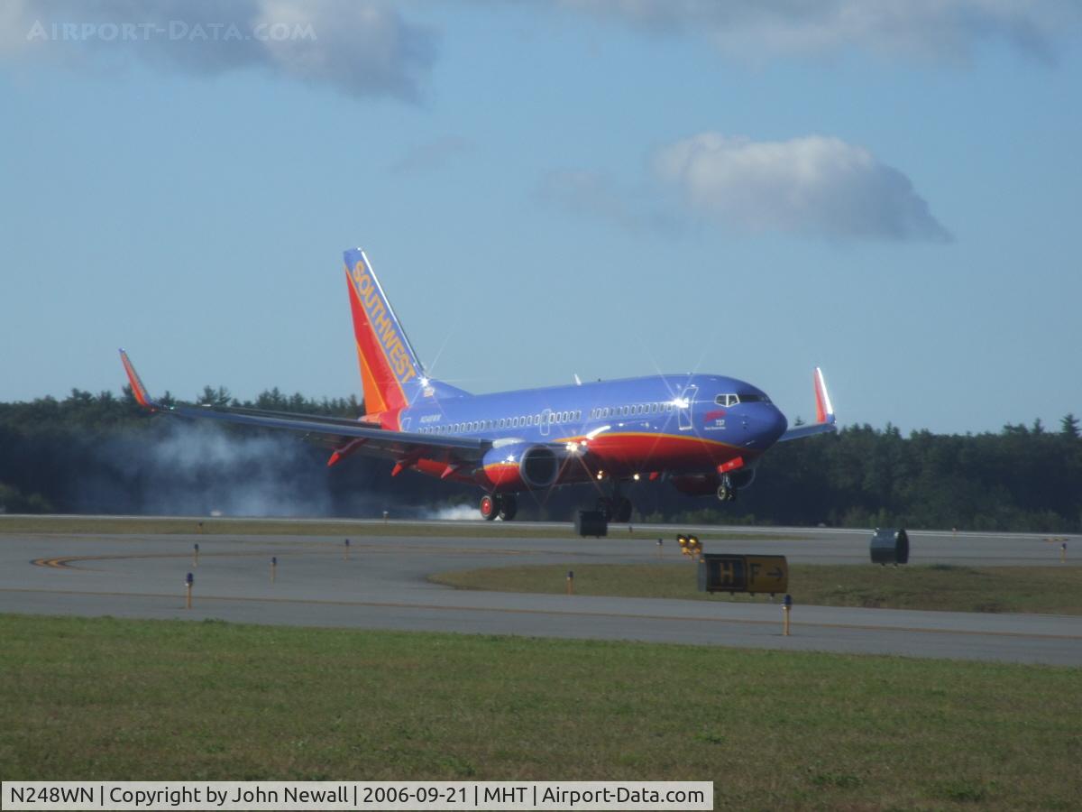 N248WN, 2006 Boeing 737-7H4 C/N 32509, shown landing on runway 35 at Manchester is the 2000th Next Generation 737 built.