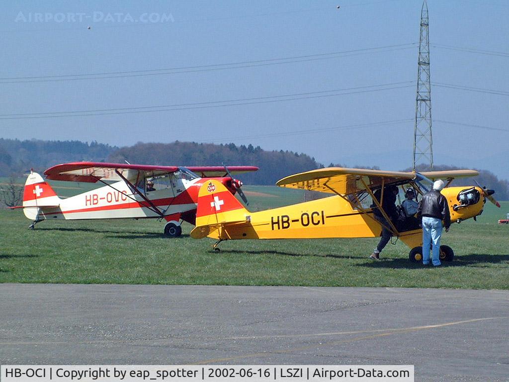 HB-OCI, 1944 Piper L-4J Grasshopper (J3C-65D) C/N 12534, together with PA-12 discussing the next flight