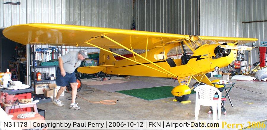N31178, 1940 Piper J-3 Cub C/N 5388, Busy man there, ducking under his starboard wing