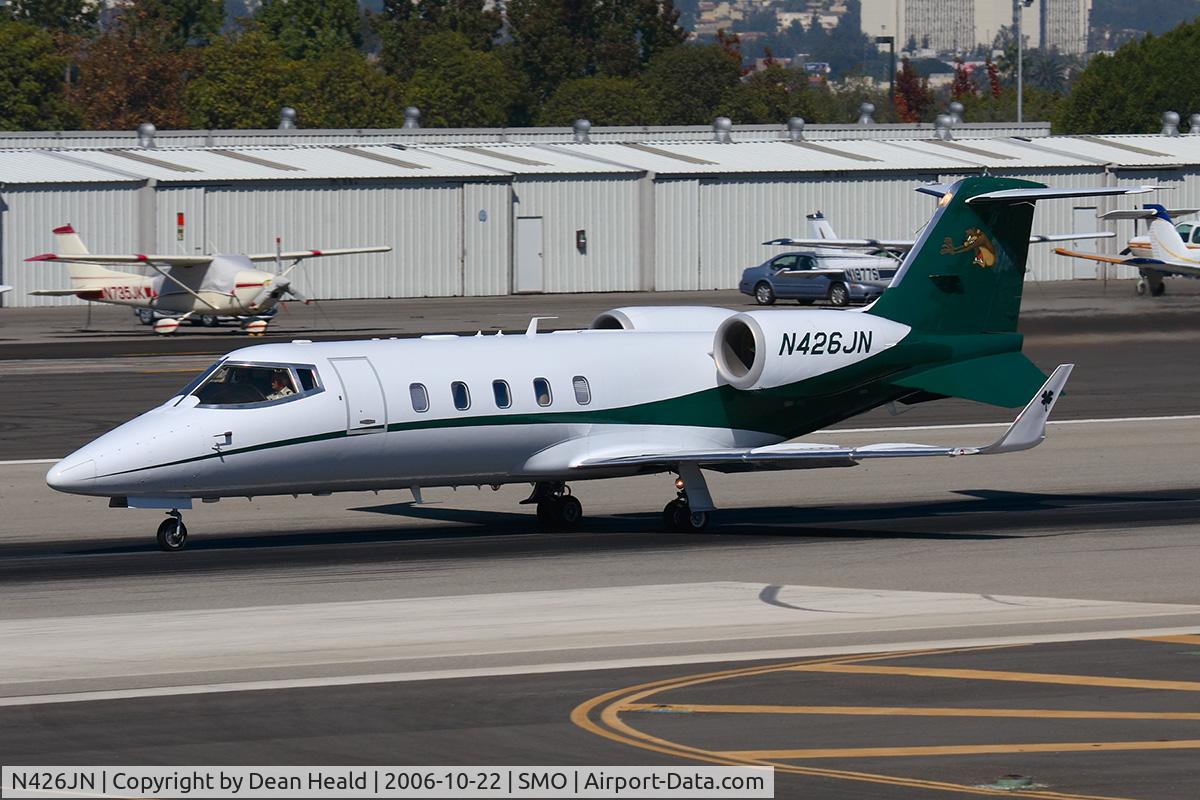 N426JN, 1998 Learjet Inc 60 C/N 142, 1998 Learjet 60 N426JN starting takeoff roll on RWY 21. Note the shamrock on the winglet and the Tasmanian Devil on the tail.