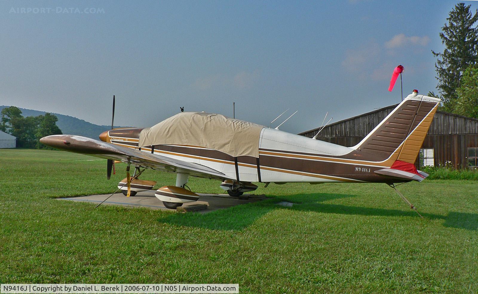 N9416J, 1966 Piper PA-28-180 C/N 28-3526, Faded but well cared-for 1966 Chrokee Archer takes refuge from the summer sun.