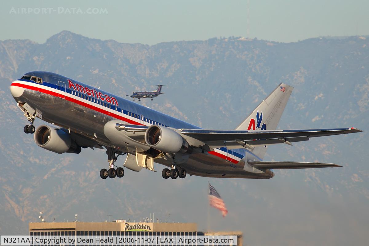 N321AA, 1986 Boeing 767-223 C/N 22322, American Airlines N321AA (FLT AAL22) climbing out from RWY 25R enroute to JFK with a SkyWest Brasilia on short final to RWY 24R.