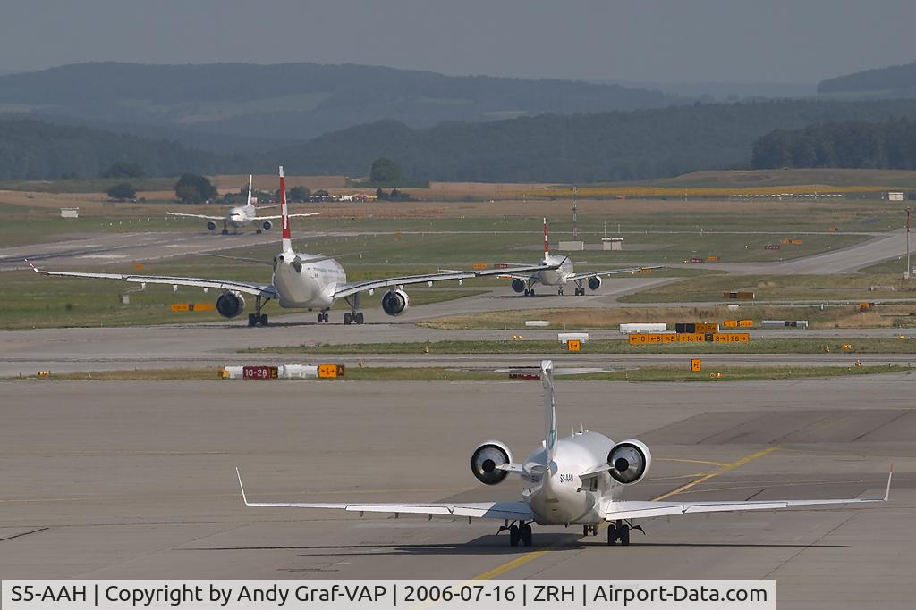 S5-AAH, 1994 Canadair CRJ-100LR (CL-600-2B19) C/N 7032, A  lot of traffic on the apron.