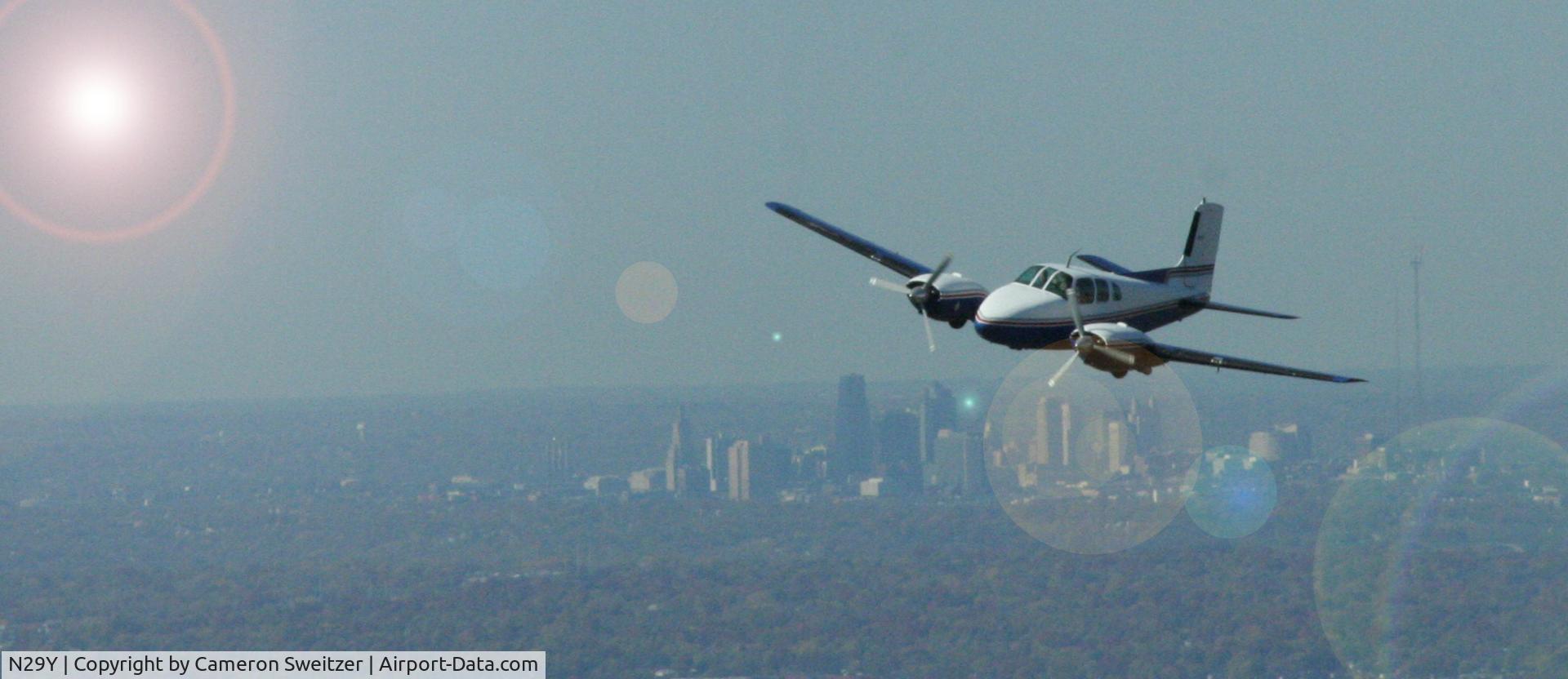 N29Y, 1957 Beech E50 Twin Bonanza C/N EH-16, Eh, thats Kansas City in the background and I photoshoped in the sun and lens glare