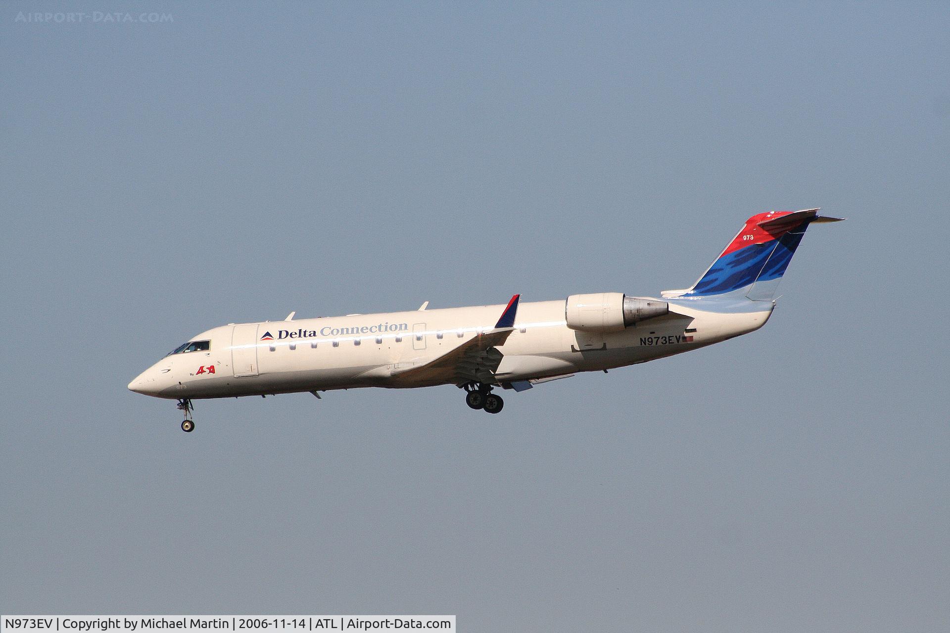 N973EV, 2002 Bombardier CRJ-200ER (CL-600-2B19) C/N 7575, Over the numbers of 27L