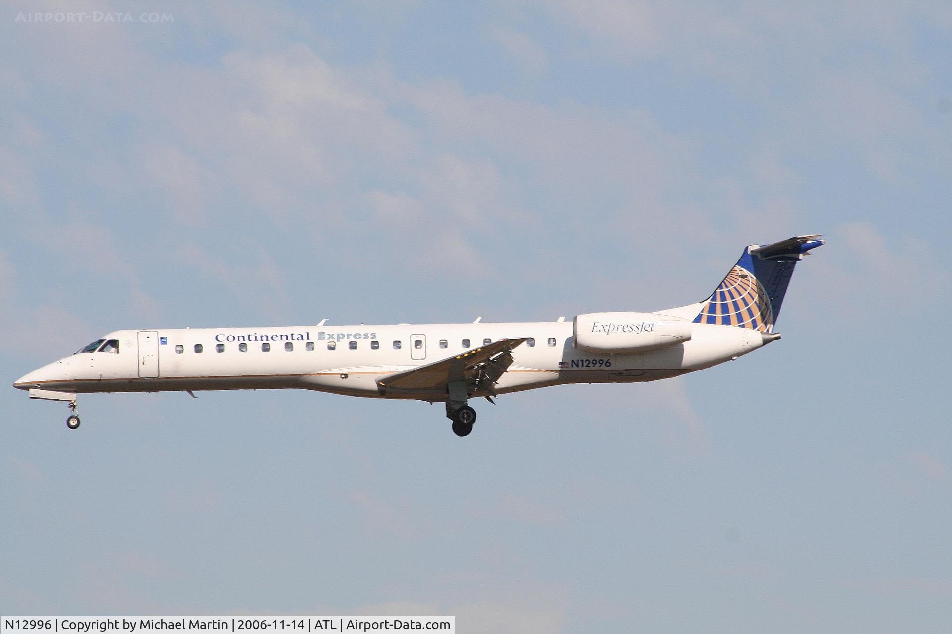 N12996, 2000 Embraer ERJ-145LR (EMB-145LR) C/N 145296, Over the numbers of 27L