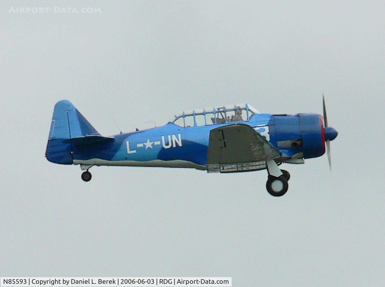 N85593, 1957 North American AT-6D Texan C/N 121-42415, Beautiful blue 1957 AT-6 makes a low pass on a gray, cloudy day.