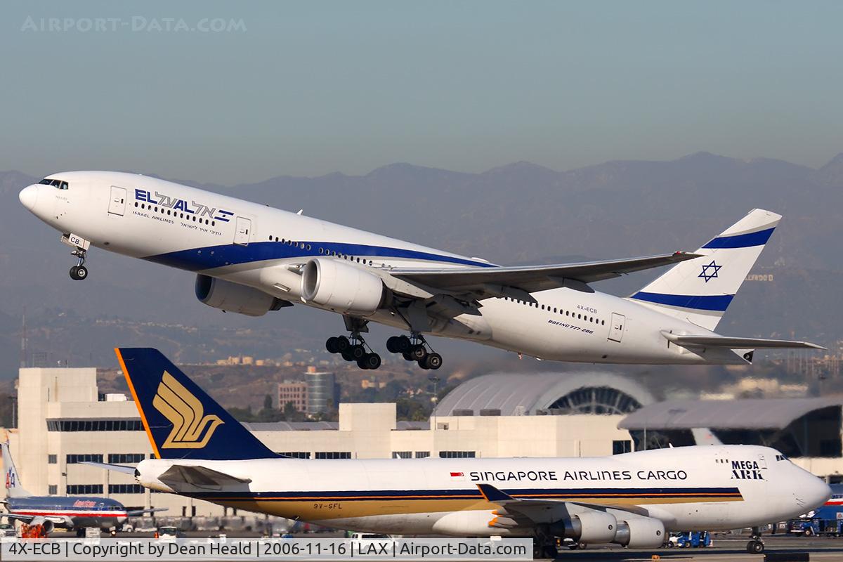 4X-ECB, 2001 Boeing 777-258/ER C/N 30832, EL AL Israel Airlines 4X-ECB (FLT ELY6) climbing out from RWY 25R enroute to Tel Aviv.  Singapore Airlines Cargo 9V-SFL is taxiing to the cargo terminal after arrival on the north complex.