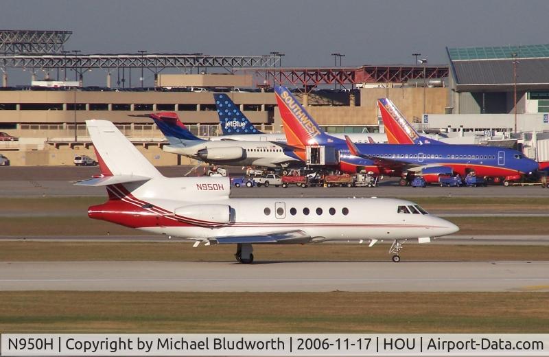 N950H, 2000 Dassault Mystere Falcon 50 C/N 307, Departs on 12R. Pretty colors behind at the terminal.