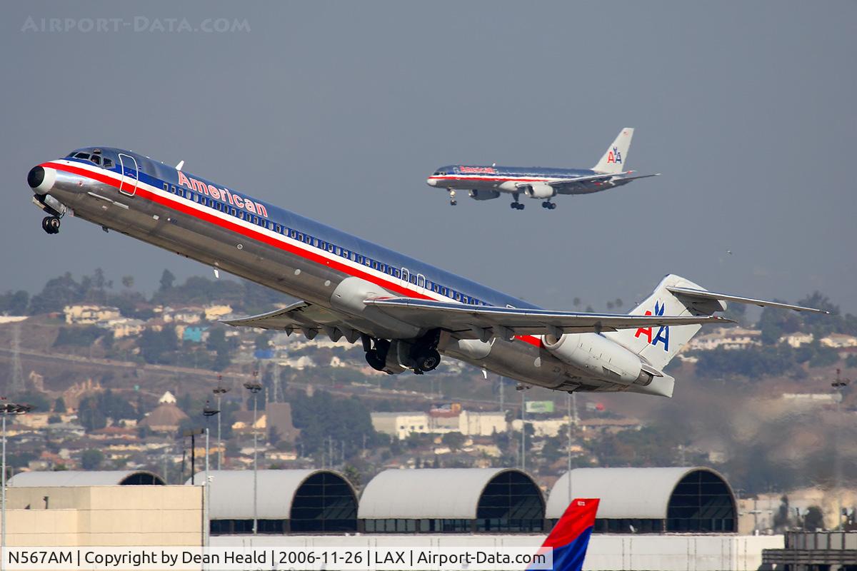 N567AM, 1992 McDonnell Douglas MD-83 (DC-9-83) C/N 53293, American Airlines N567AM (FLT AAL2448) climbing out from RWY 25R enroute to Dallas Fort Worth Int'l (KDFW), while American Airlines FLT AAL309 from Chicago O'Hare Int'l (KORD) is on short-final to RWY 24R.