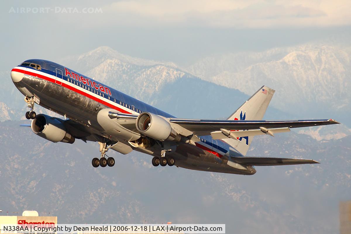 N338AA, 1987 Boeing 767-223 C/N 22335, American Airlines N338AA (FLT AAL22) climbing out from RWY 25R enroute to Dallas Fort Worth Int'l (KDFW) with the snow-capped San Gabriel Mountains in the background.