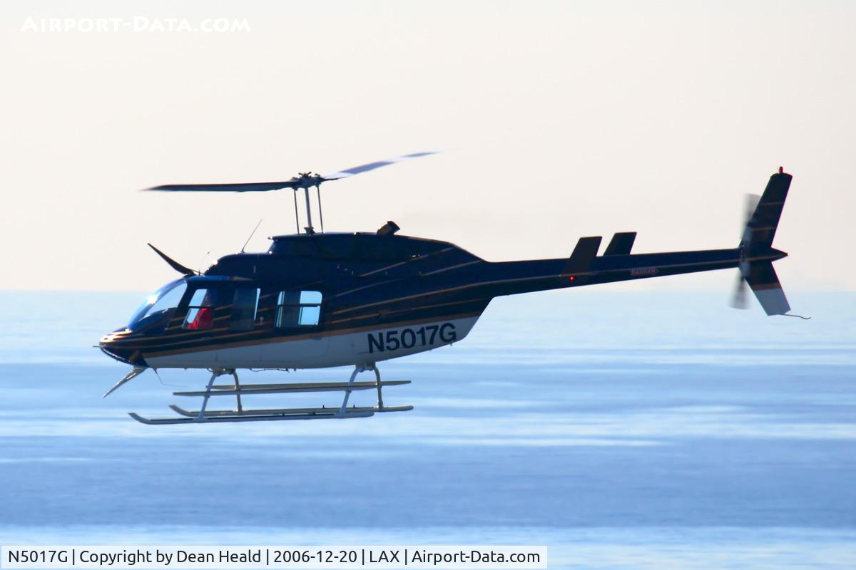 N5017G, Bell 206L-1 LongRanger II C/N 45228, Backlit shot of a 1979 Bell Textron 206L-1 JETRANGER III N5017G headed southbound less than 100 ft AGL off the west end of LAX.
