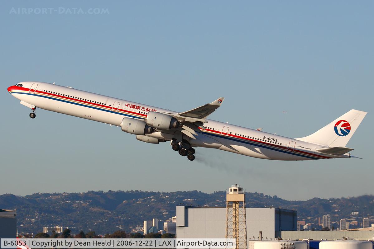 B-6053, 2004 Airbus A340-642 C/N 577, Running late today, China Eastern B-6053 (FLT CES586), climbing out from RWY 25R trailing brake dust, enroute to Shanghai Pudong (ZSPD).