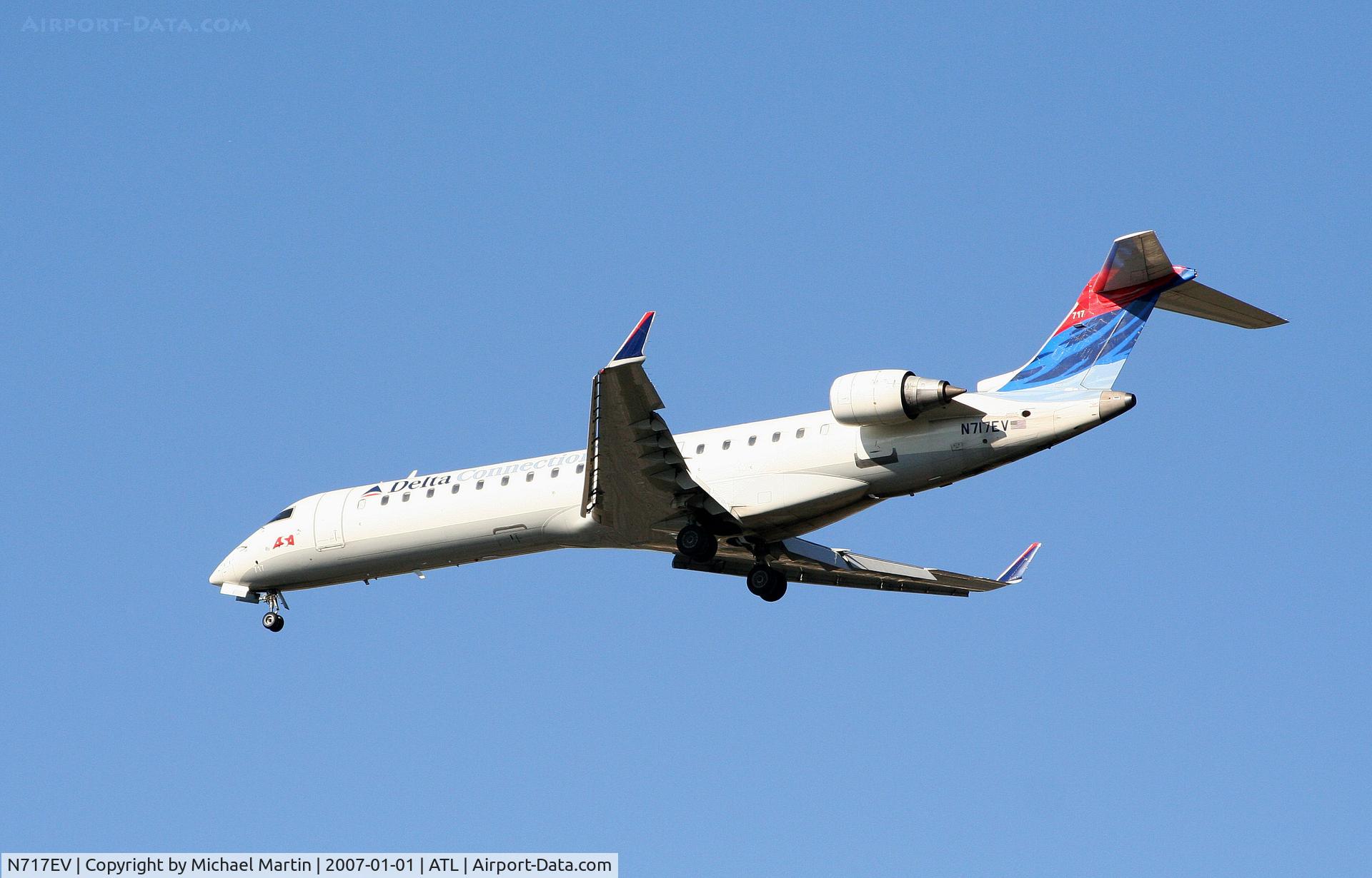 N717EV, 2003 Bombardier CRJ-701 (CL-600-2C10) Regional Jet C/N 10088, Over the numbers of 26L