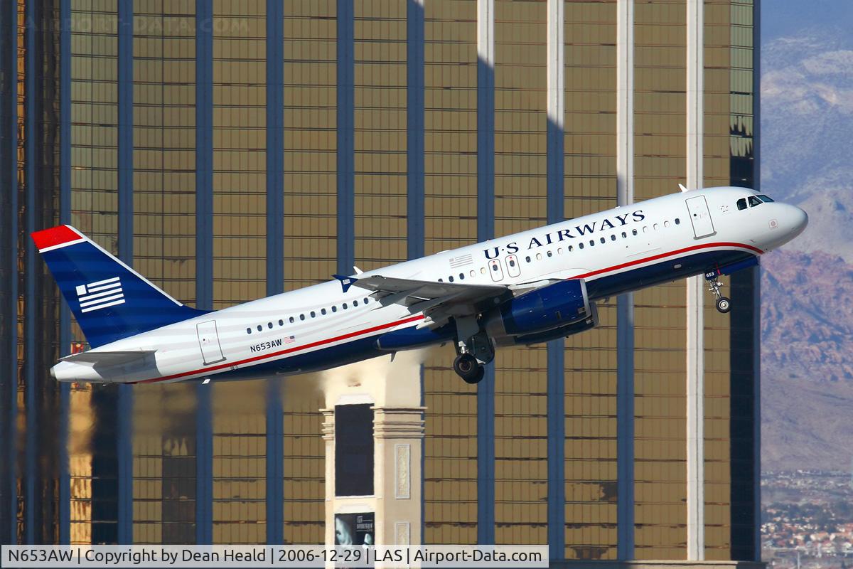 N653AW, 1999 Airbus A320-232 C/N 1003, US Airways (America West) N653AW (FLT AWE103) climbing out from RWY 01R in front of Mandalay Bay enroute to Los Angeles Int'l (KLAX).