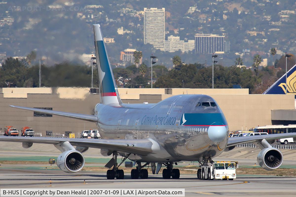 B-HUS, 1991 Boeing 747-444/BCF C/N 25152, Cathay Pacific Cargo B-HUS being towed through the alley enroute to the cargo terminal.