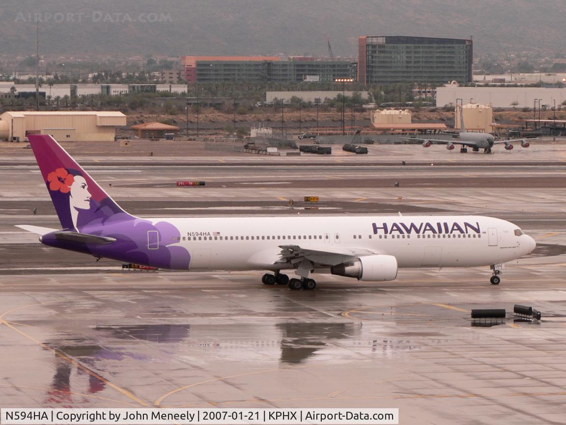 N594HA, 1986 Boeing 767-332 C/N 23275, Taxiing for runway 7L on a cold and wet January day in normally sunny Phoenix