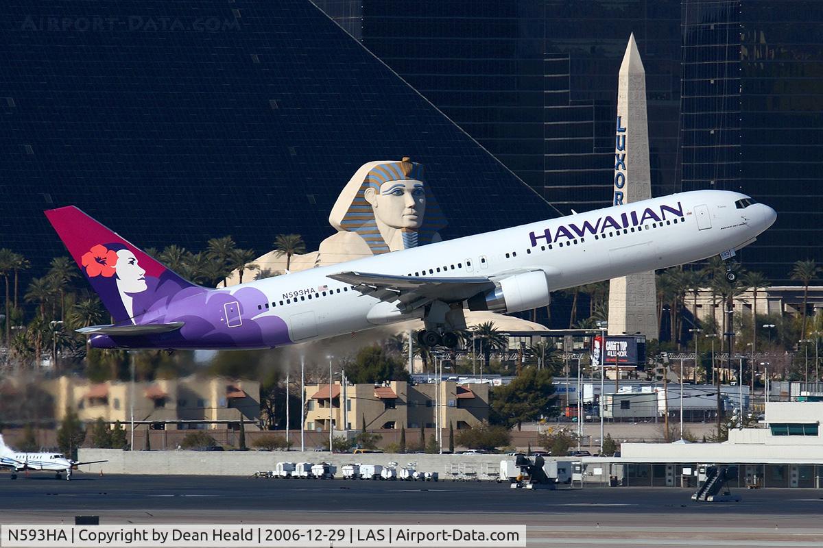 N593HA, 2003 Boeing 767-33A C/N 33424, Hawaiian Airlines N593HA (FLT HAL7) climbing out from RWY 01R, in front of the Luxor Hotel & Casino, enroute to Honolulu Int'l (PHNL).