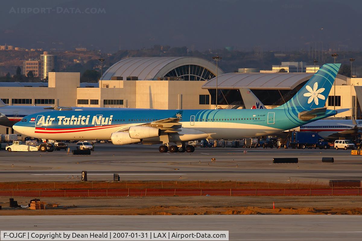 F-OJGF, 2001 Airbus A340-313 C/N 385, Air Tahiti Nui F-OJGF being towed into her gate at the Tom Bradley International Terminal (TBIT) late in the day.