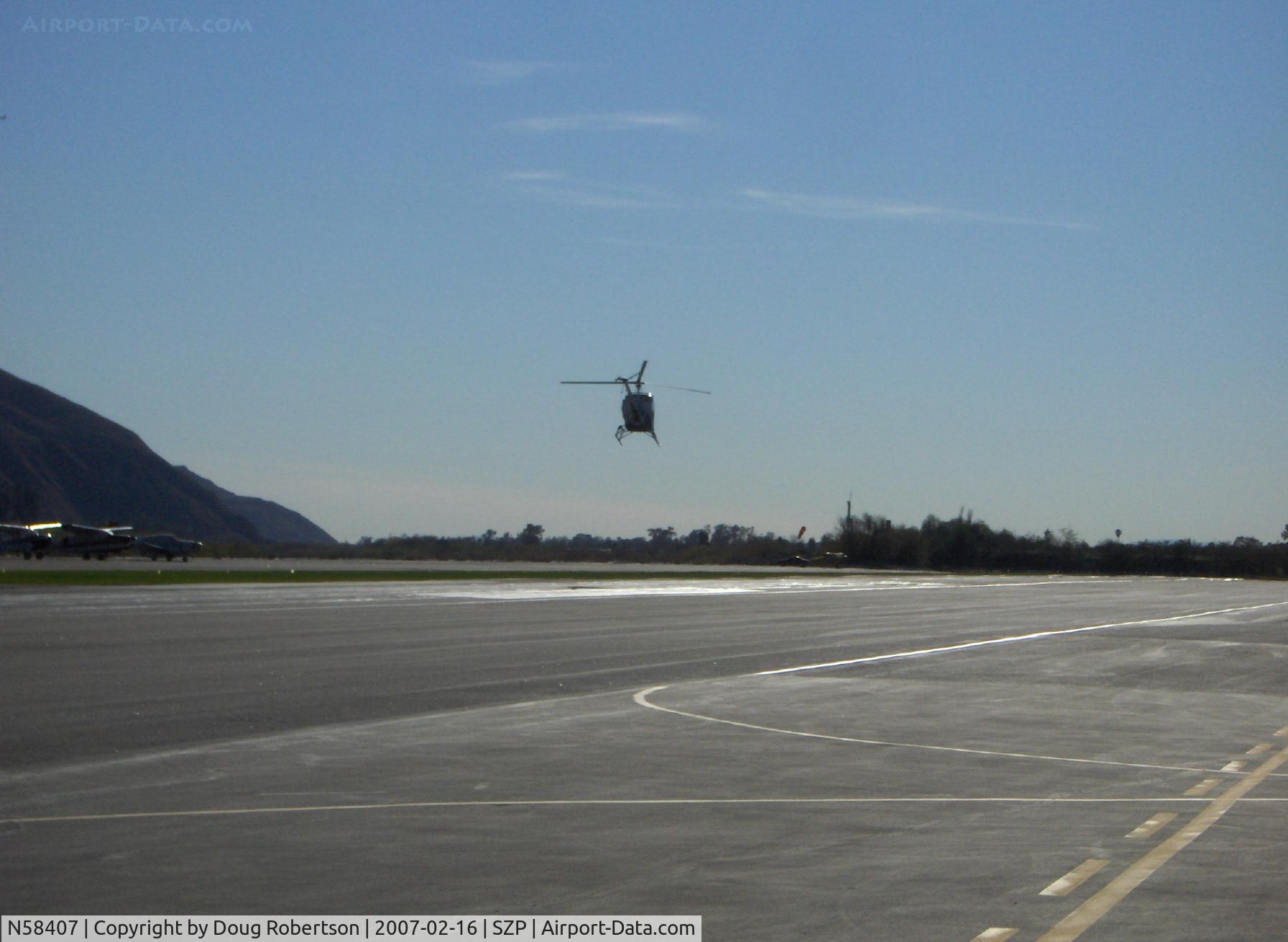 N58407, 1979 Hughes 269C C/N 1190846, 1979 Hughes 269C Helicopter, Lycoming HIO-360-D1A 190 Hp, departing SZP Helipad on Rwy 22