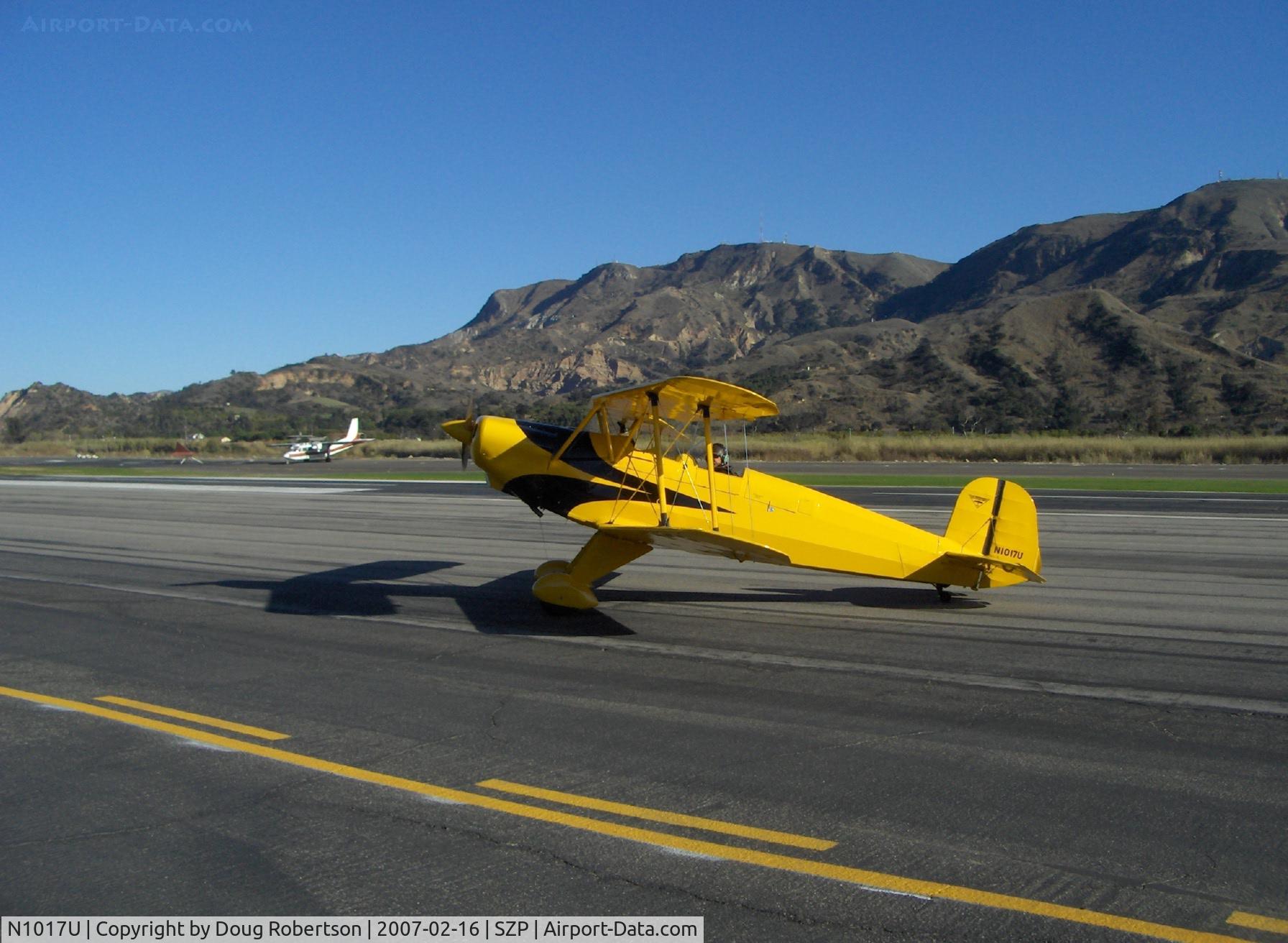N1017U, 1939 CASA 1-131 Jungmann C/N E3B-435, 1939 Bucker Jungmann C.A.S.A. 1.131, Lycoming O-360 180 Hp upgrade, owner/pilot 'posing' aircraft for photographer by stopping taxi. Thank You, Pat!