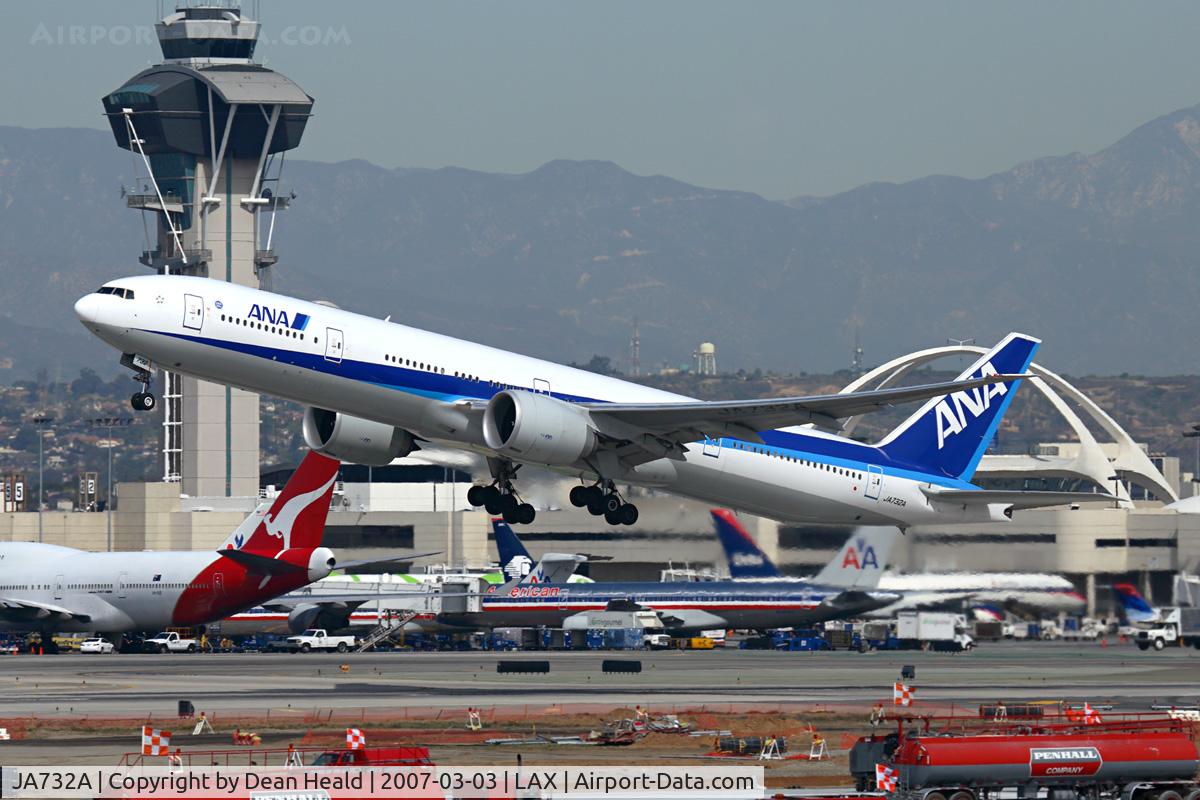 JA732A, 2005 Boeing 777-381/ER C/N 27038, A classic view from the Imperial Hill of All Nippon Airways JA732A (FLT ANA5) departing RWY 25R enroute to Narita Int'l (RJAA). The tower and more significantly, the Theme building are well-known, defining landmarks of LAX.