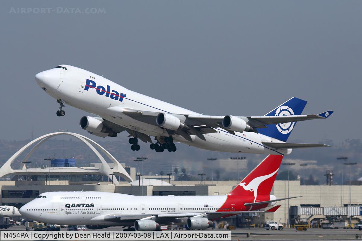 N454PA, 2002 Boeing 747-46NF C/N 30812, Polar Air Cargo N454PA (FLT PAC283) climbing out from RWY 25R enroute to Incheon Int'l (RKSI). Qantas VH-OJI (FLT QFA25) from Auckland Int'l (NZAA) is taxiing to the TBIT.