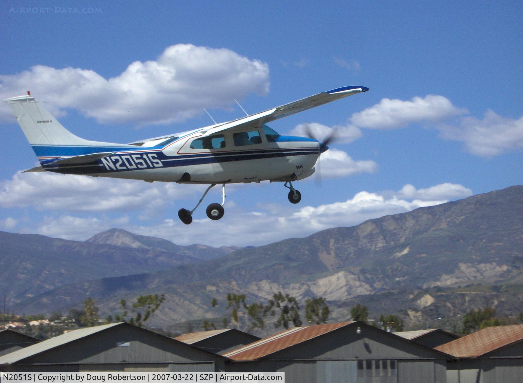 N2051S, 1975 Cessna 210L Centurion C/N 21061018, 1975 Cessna 210L CENTURION, Continental IO-520-L 300 Hp, takeoff climb Rwy 04 with 'Crazylegs' gear retraction. (6,704 foot Hines Peak beyond the saddle).