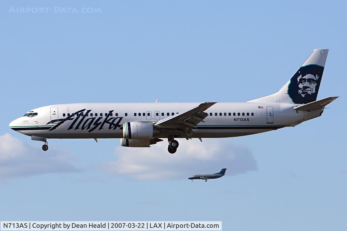 N713AS, 1999 Boeing 737-490 C/N 30161, Alaska Airlines N713AS (FLT ASA243) from Playa De Oro Int'l (MMZO) - Manzanillo, Mexico on short final to RWY 25R. The Skywest Brasilia is on approach to RWY 24R.