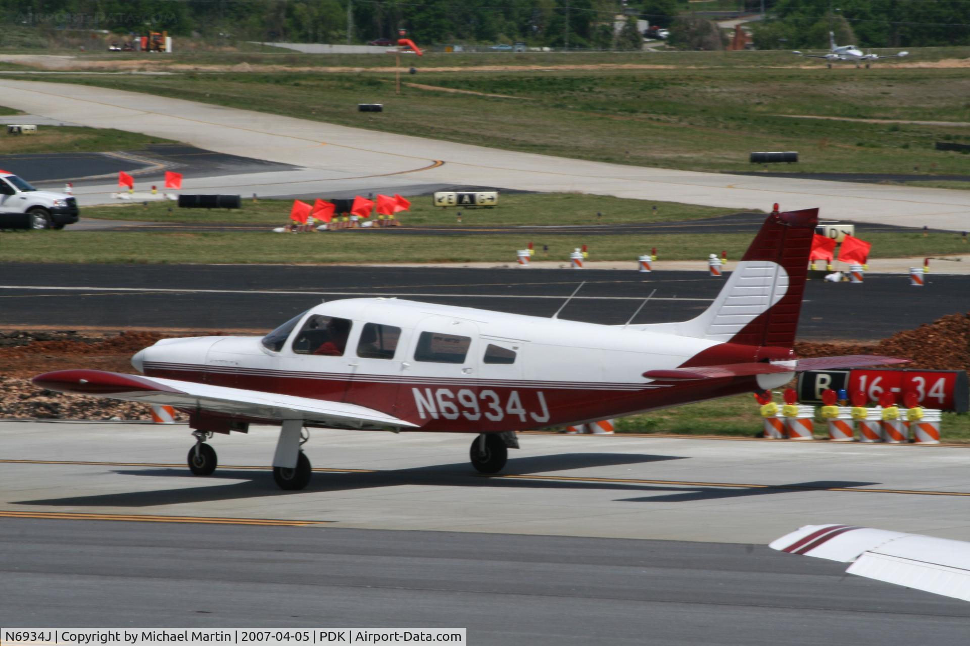N6934J, 1976 Piper PA-32R-300 Cherokee Lance C/N 32R-7680389, Taxing past on going construction