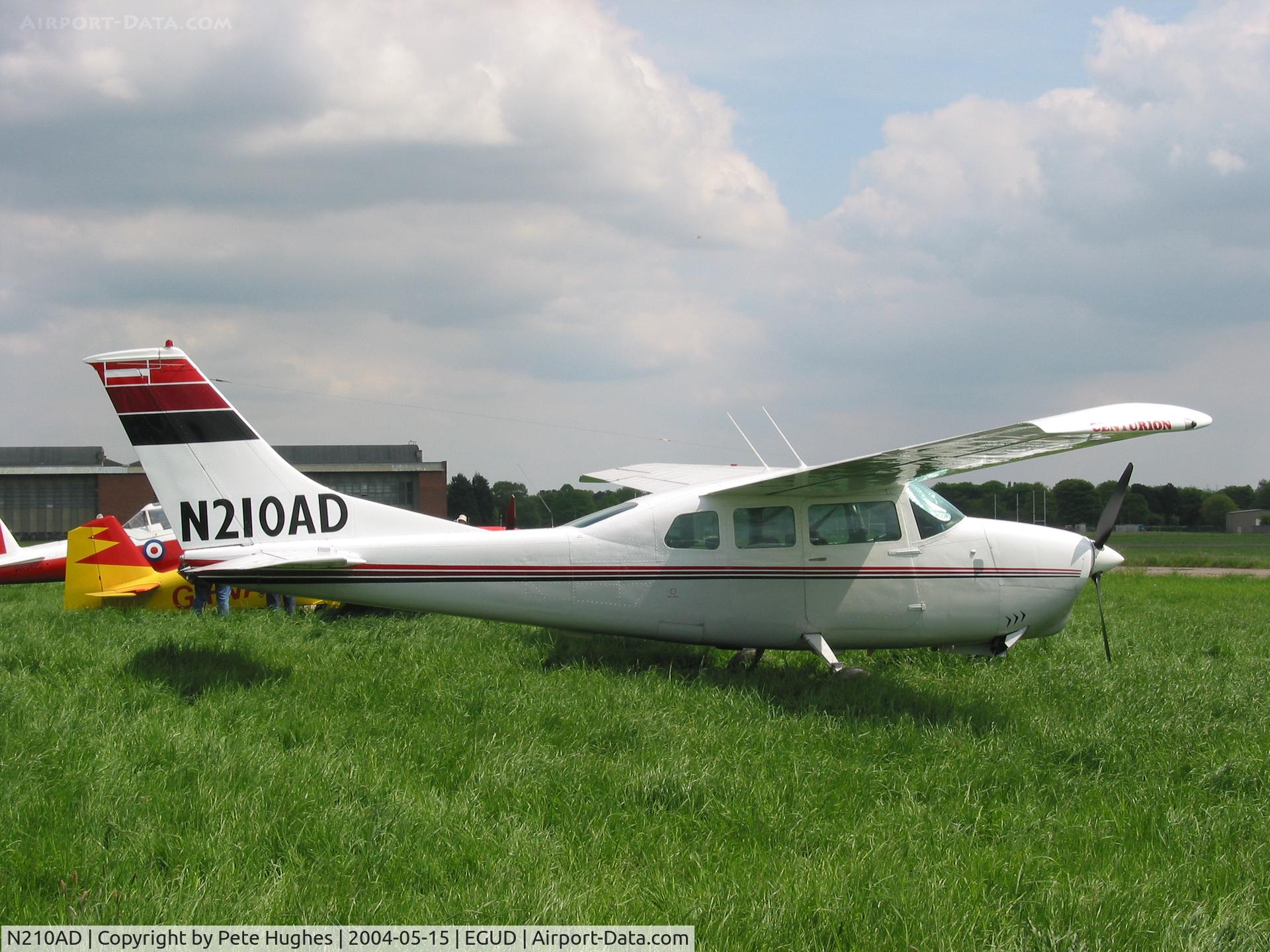N210AD, 1967 Cessna 210G Centurion C/N 210-58835, parked in long grass at the GVFWE - Great Vintage Flying Weekend - at RAF Abingdon 15 May 2004
