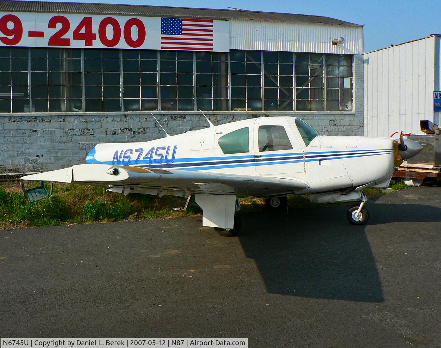 N6745U, 1963 Mooney M20C Ranger C/N 2467, Bereft of her tail feathers, this 1963 Mooney sits forlornly behind the main hangar building.