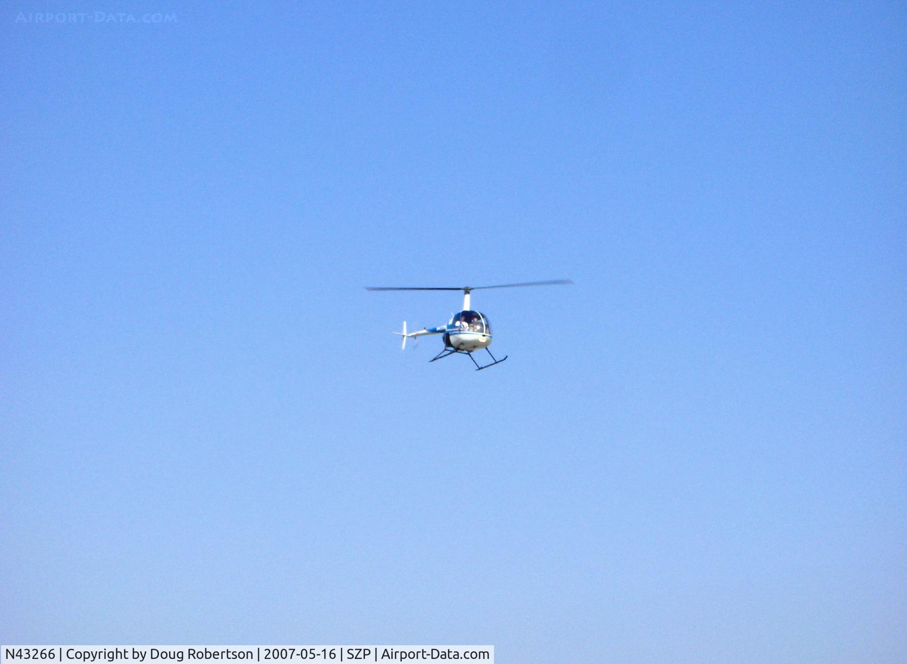 N43266, 1990 Robinson R22 Beta C/N 1268, 1990 Robinson R22 Beta, Lycoming O-320-BC, landing approach to helipad over Rwy 22
