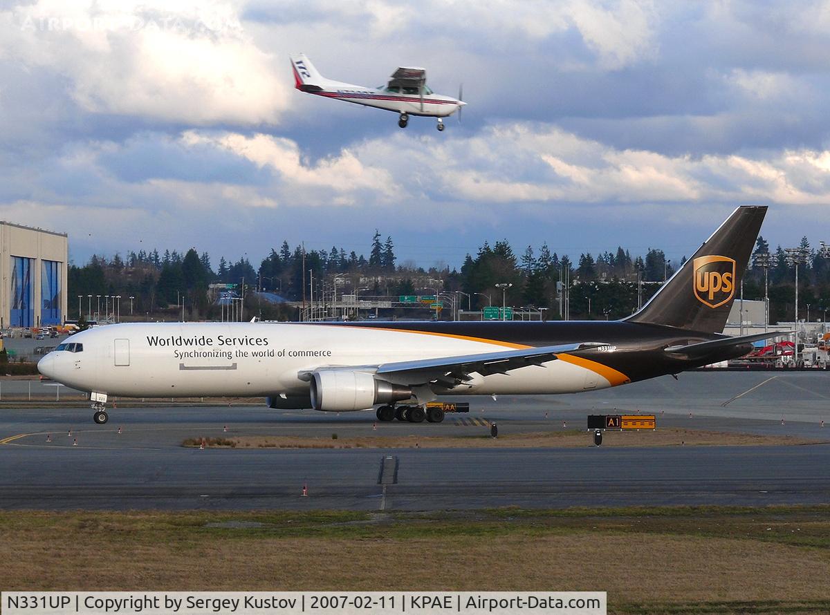 N331UP, 1999 Boeing 767-34AF C/N 27757, Taxiing to 16R with Cessna above.