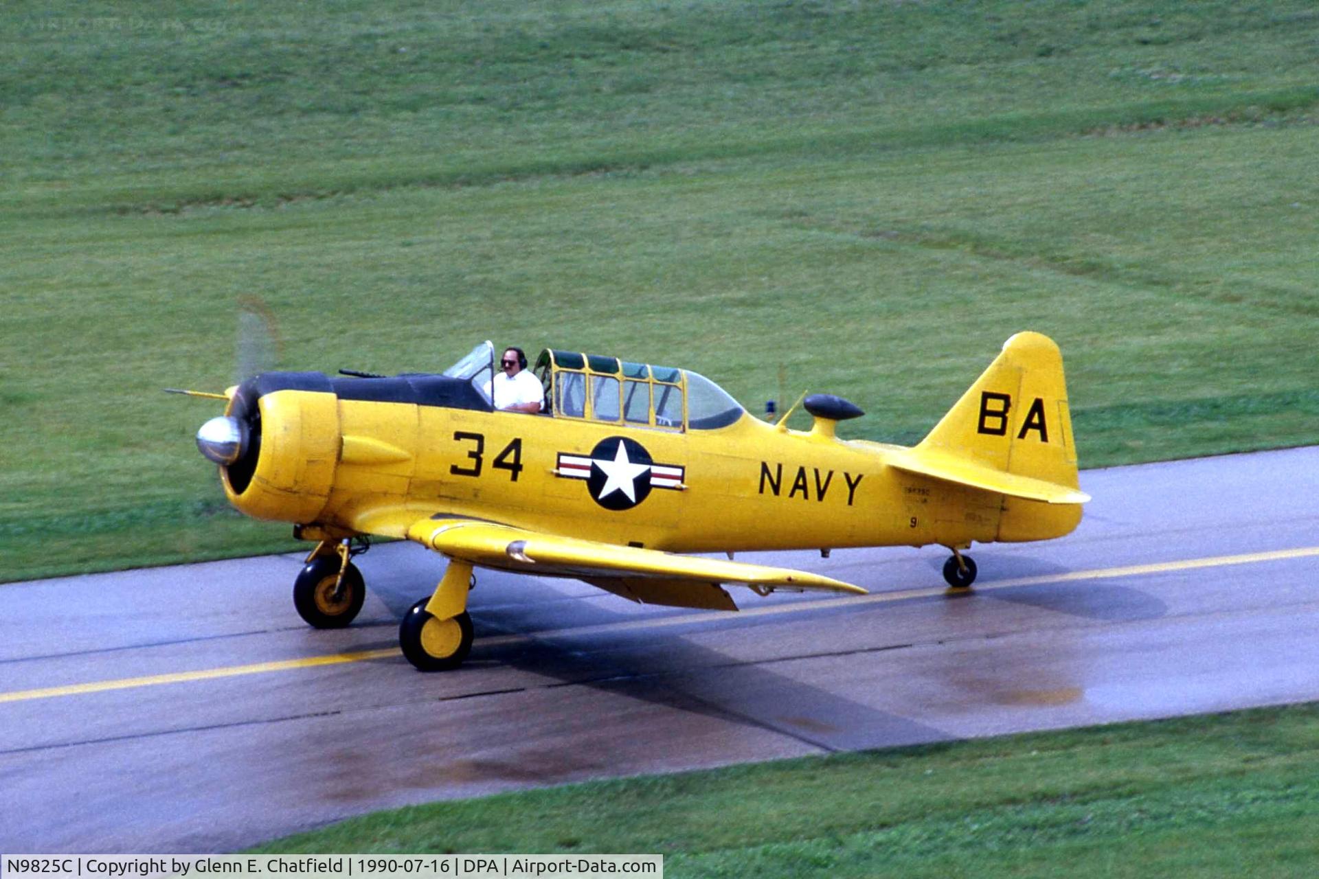 N9825C, 1945 North American SNJ-6B Texan C/N 111987, Taxiing by the control tower