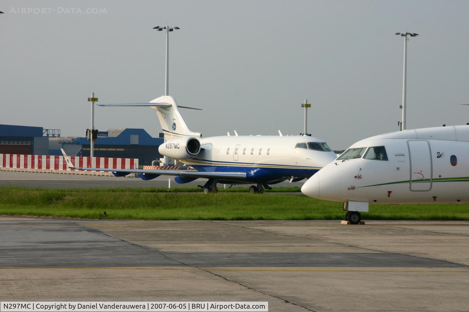 N297MC, 2006 Bombardier Challenger 300 (BD-100-1A10) C/N 20127, partly hidden by Do328-J300 OE-HTJ