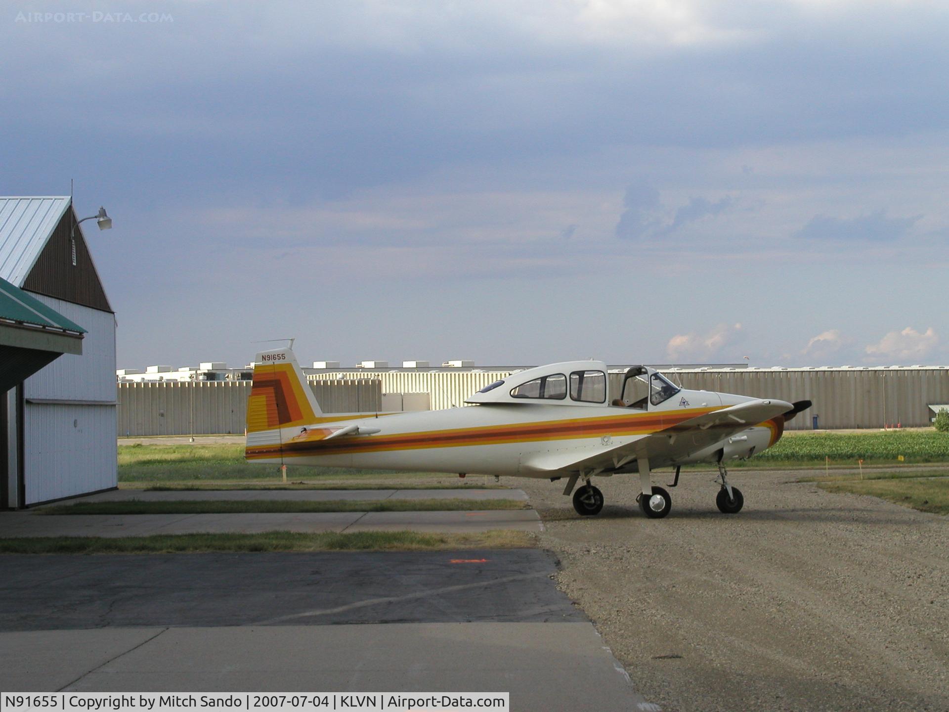 N91655, 1946 North American Navion (NA-145) C/N NAV-4-405, Navion parked infront of it's hangar at Airlake.